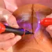 a person painting a red substance