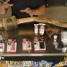 a person lying on a table with a large bottle of alcohol